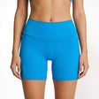 Blue athletic shorts worn by a person on a plain background